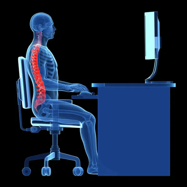 Person at a desk practicing balanced sitting posture
